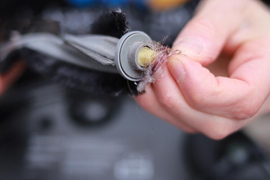 You can see hair wrapped around the brush of the Ecovacs Deebot X1 OMNI.